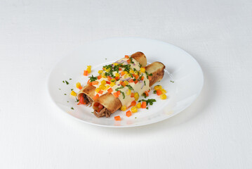 quinoa with meat in a white plate sprinkled with vegetables on a white background macro