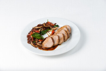 brown rice with mushrooms, vegetables and meat in a white plate 