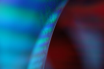 Blue multicoloured liquid surface on black background, interference pattern, one colourful curved line