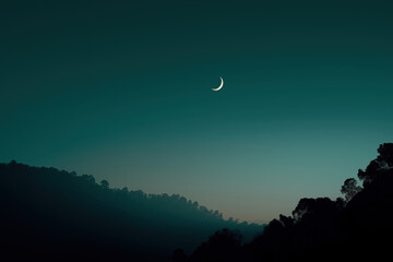 Crescent moon at dusk over silhouetted horizon with calm navy-to-teal gradient sky, soft ambient glow hero image