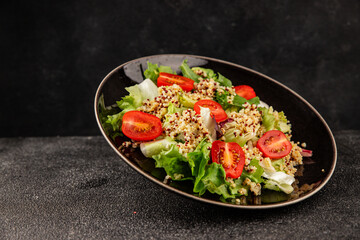 Quinoa salad tomato, green leaf salad vegetables dish natural product tasty snack fresh gourmet food background on the table rustic top view copy space keto and paleo diet vegan and vegan food