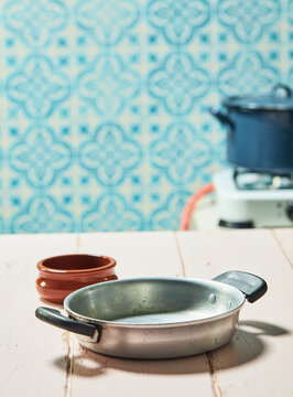 pot on a rustic pink table in a kitchen setting