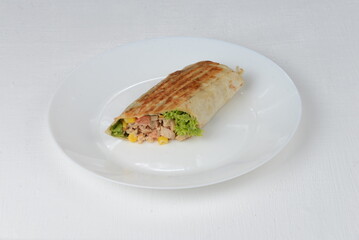 fajito with chicken and vegetables in a white plate on a  background