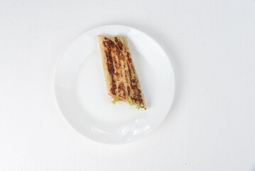 fajito with teolatina and vegetables in a white plate on a white background 