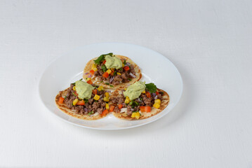 tacos with veal on a white plate on a background 