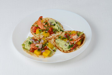 Shrimp tacos on a white plate on a white background