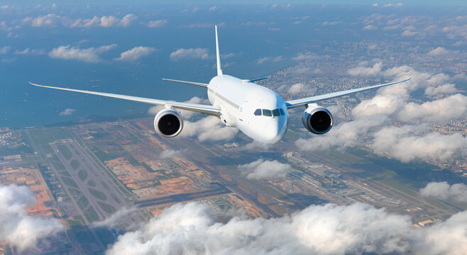 Airplane taking off from airport - Passenger airplane is flying over amazing mountains and sea - Commercial Tankers and container ships wait in the Straits of Singapore Changi Airport - Powered by Adobe