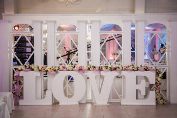 Creative love display at a wedding venue with elegant decor and floral arrangements