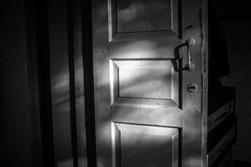 Black and White Old Wooden Door with Dramatic Shadows