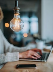 Glowing Edison light bulb symbolizing a bright idea over a workspace.