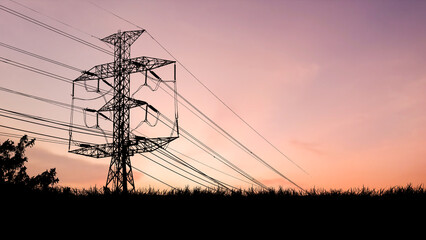 Energy Silhouette: A dramatic silhouette of a power line tower against a vibrant, colorful sky at...