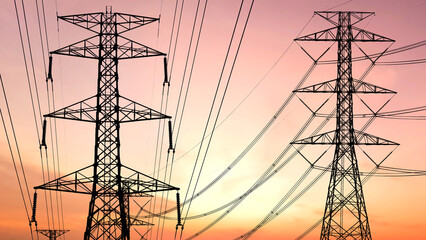 Power Grid Pylons at Sunset: The dramatic silhouettes of towering power pylons reaching towards the vibrant hues of the setting sun, a symbol of power, energy, and technological infrastructure.