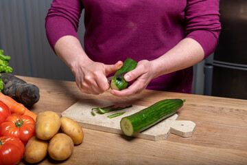 Woman Preparing a Healthy Meal with Fresh Vegetables in the Kitchen