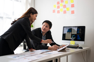 Business people discussing and working with financial charts in office