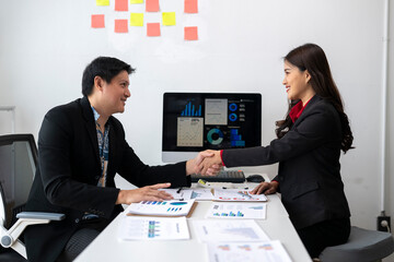 Business people shaking hands after successful meeting in office