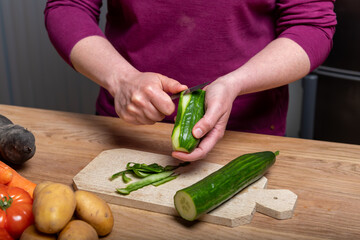Woman Preparing a Healthy Meal with Fresh Vegetables in the Kitchen