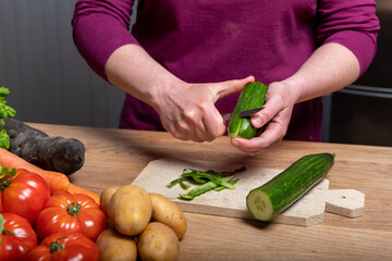 Woman Preparing a Healthy Meal with Fresh Vegetables in the Kitchen