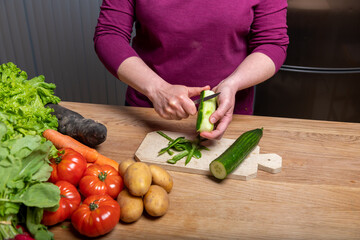 Woman Preparing a Healthy Meal with Fresh Vegetables in the Kitchen