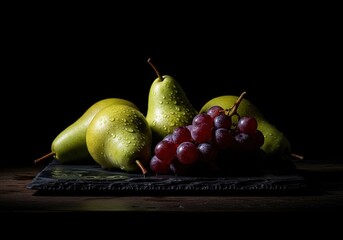 Dramatic still life of fresh green pears and red grapes with water drops on a slate board