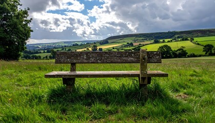 Serene Wooden Bench Overlooking Lush Green Fields and Hills