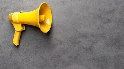 Yellow Megaphone on Gray Textured Background