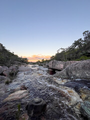 Obraz premium Rocky river at sunset with flowing water