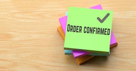 Order Confirmed text on colorful sticky note on wooden desk, business absence reminder concept