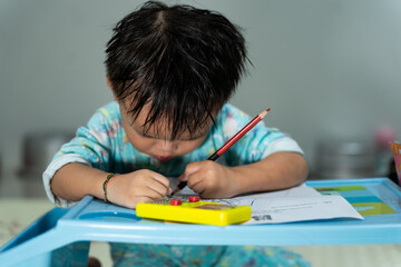 Toddler Drawing with Pencil on Paper at Home