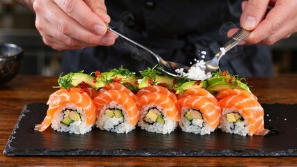 Culinary Masterpiece: Chef Drizzling Delicate Garnish on Freshly Prepared Salmon Sushi Rolls, a Fusion of Flavors and Textures.