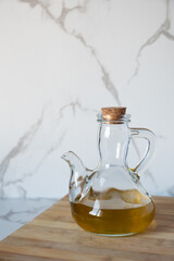 Olive oil cruet on wood table for healthy cooking