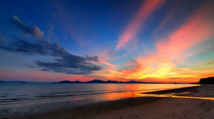 A breathtaking tropical beach sunset with vibrant clouds and golden reflections on the wet sand.