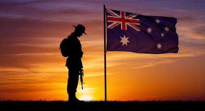 Silhouette of Anzac soldier with the Australian flag at sunset memorial