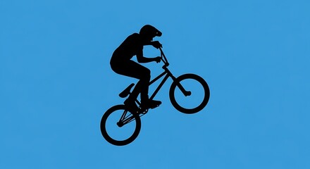 Fototapeta premium BMX Rider Silhouette Performing a Wheelie Stunt.