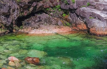 A flowing rocky river, green water of mountain river stream