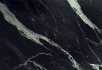 Dark black marble surface with elegant white and grey veins running across. Luxurious stone texture perfect for architecture, countertops or design backdrops with a modern sophisticated look.