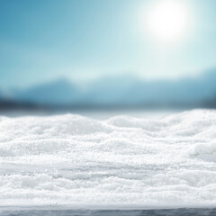 Snow covered copy space for product placement and snowy mountain landscape in the heart of winter, with tree-covered slopes and frosty pine forests under  bright winter sky.
