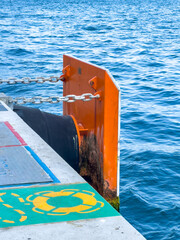 Protective board and mooring rope at the pier by the sea