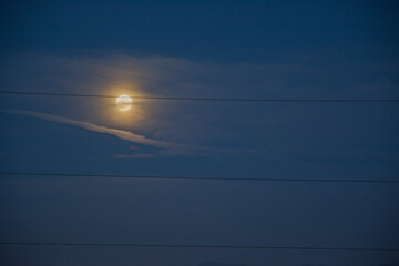 Full Moon Behind Clouds with Power Lines at Night