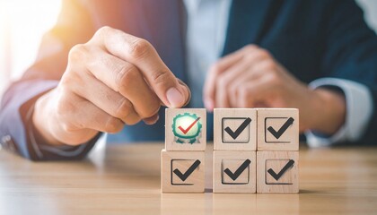 A suited hand places a green checkmarked block atop a pyramid of black-marked blocks—set on white—evokes crafted completion, symbolic validation, and the rhythm of structured achievement and control.