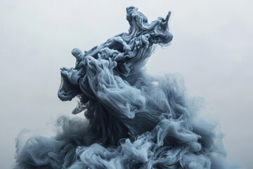 Grey ink swirling and mixing in water against a pale background, creating an ethereal and abstract underwater cloud formation.