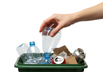 Hand placing plastic bottle into a green recycling bin filled with various recyclable materials, promoting environmental awareness and waste reduction.