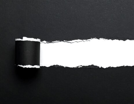 Ripped black paper reveals white