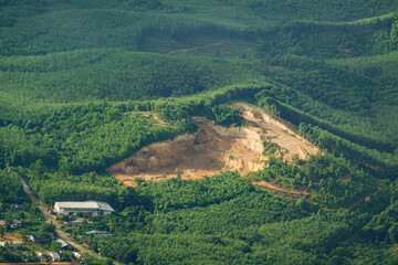 Obraz premium Mountains with green forests are being destroyed for urban growth