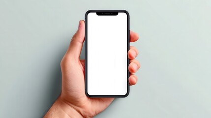 Person Holding a Smartphone in a Minimalistic Setting with Blank Screen
