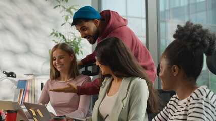 Informal business team happy three diverse multiracial women businesswomen working together in office Arabian businessman Indian startup CEO company owner coming showing thumb up good result support