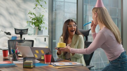 Birthday celebration corporate office amazed happy Indian businesswoman Arabian woman laptop busy diversity friendly business coworkers surprising holding festive cake informal startup team two women