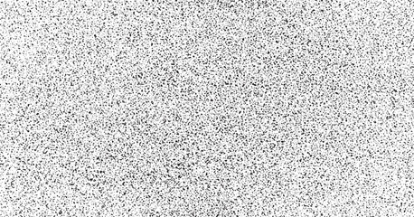 Speckled abstract background with black spots on white surface resembling a terrazzo texture