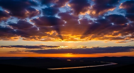 Dramatic sunset over a winding river, with vibrant colors and cloud formations.