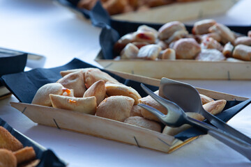 Panzerotti and other pastries served on a table during a buffet, ready to be eaten