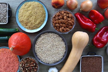 Assortment of various healthy fruits, vegetables, grains and legumes. Top view, wooden background.
